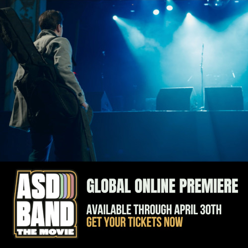 ASD Band: The Movie. Global Online Premiere. Available Through April 30th. Get your tickets now. Image of a man wearing a green jacket and a guitar over his shoulder walking to a stage with a microphone backlit by stage lights.