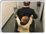 Little Boy Pushing Wheelchair